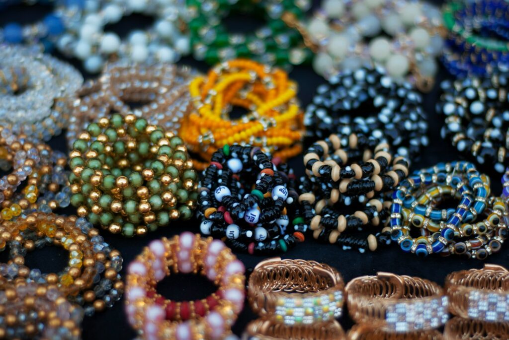 A table topped with lots of different types of bracelets